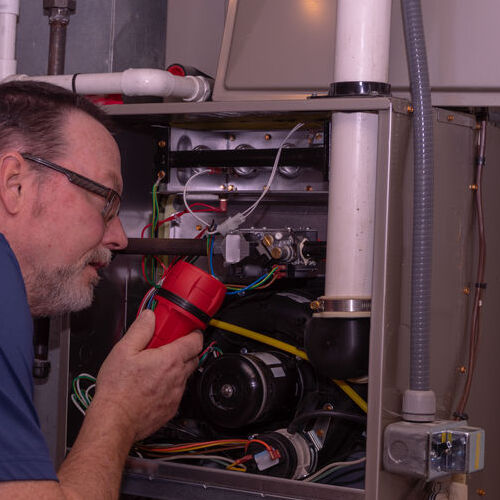 HVAC contractor checks furnace.