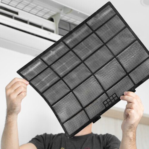 Technician changes HVAC filter