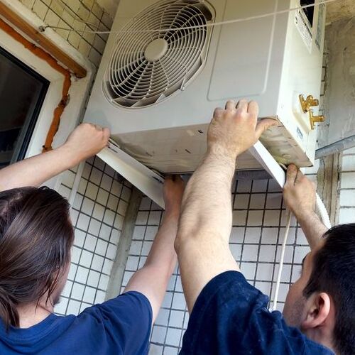 HVAC contractor installs an air conditioner