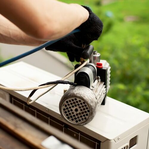 HVAC contractor prepares to install AC unit.