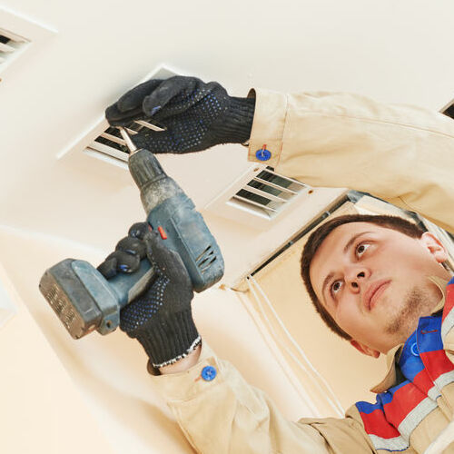 HVAC technician installs vents.