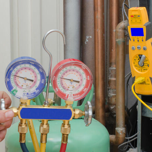 An HVAC contractor refills refrigerant.