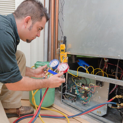 HVAC contractor works on a furnace