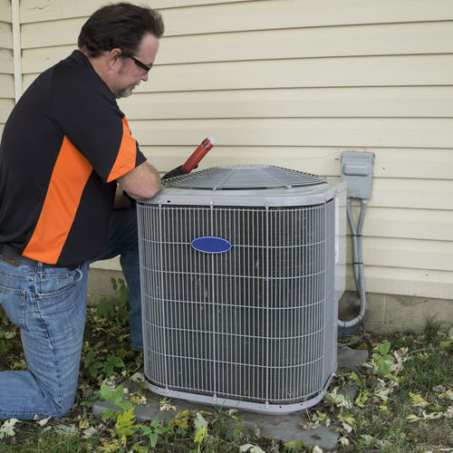 HVAC contractor inspects an AC unit.