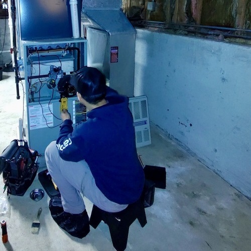 Technician works on a heater.